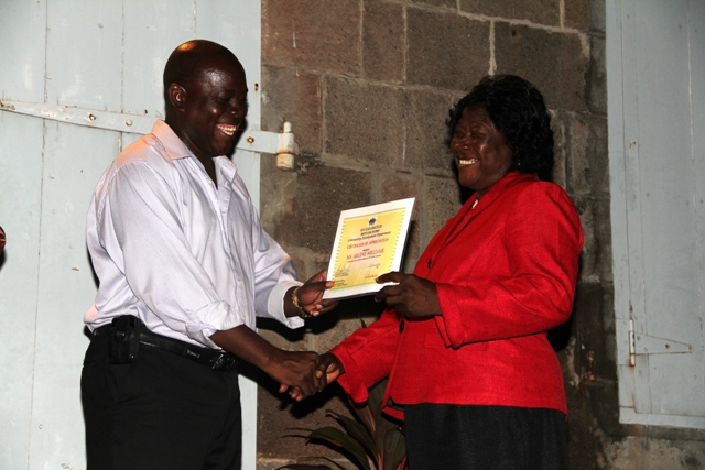 Area Representative for the St. Paul’s Parish the Honourable E. Robelto Hector presents recognition certificate to Ms. Arlene Williams