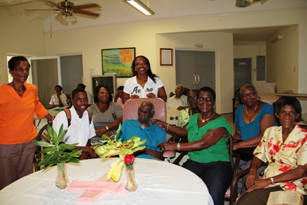 A family member smiles with birthday boy Mr. Arnold Chiverton of Beach Road