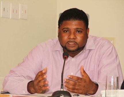 Junior Minister responsible for Communications and Works in the Nevis Island Administration Hon. Troy Liburd delivering a report at the a town hall meeting hosted by the Administration on November 07, 2013, at the Red Cross conference room on Chapel Street
