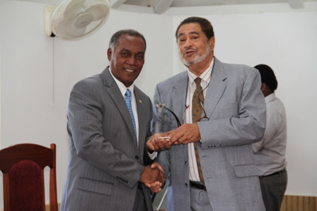 Premier of Nevis Hon. Vance Amory receiving a plaque from Deputy Governor General His Honour Eustace John from the Nevis Island Assembly as one of the longest serving parliamentarian at a special sitting of the Assembly on December 10, 2013 at the at its Chambers in Hamilton House
