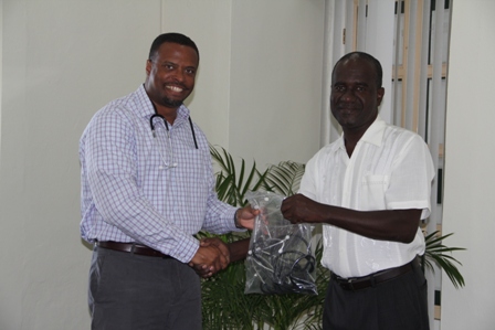 (L-R) Deputy Premier of Nevis and Minister of Health Hon. Mark Brantley receives medical supplies at his Bath Plain office on February 17, 2014, from Global Faith Alliance through a partnership with Pastor Davidson Morton of the Eden Browne Church of God at Butlers Village, Nevis