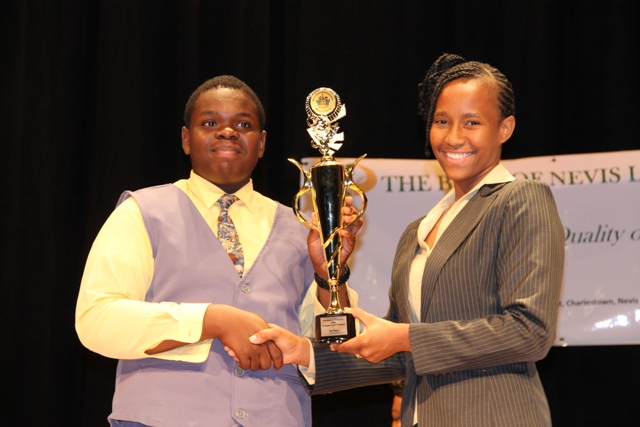 (l-r) First place winner of the 2014 Bank of Nevis Ltd. Tourism Youth Congress Rol-J Williams receives trophy from Bank of Nevis Marketing Officer Bronte Swanston-Hendrickson