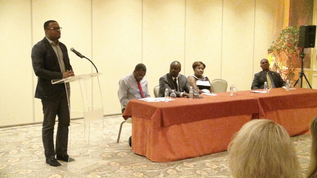 Deputy Premier of Nevis and Minister of Tourism Hon. Mark Brantley delivering remarks at the inaugural Nevis Travel Symposium of Romance for travel professionals at the Four Seasons Resort on October 19, 2015, hosted by the Nevis Tourism Authority. Sitting at the head table are (l-r) Director of Sales and Marketing at the Nevis Tourism Authority and Chairman for the ceremony Devon Liburd, Chief Executive Officer of the Nevis Tourism Authority Greg Phillip, Chief Executive Officer of Dreamy Weddings Nathalie John and Premier of Nevis Hon. Vance Amory