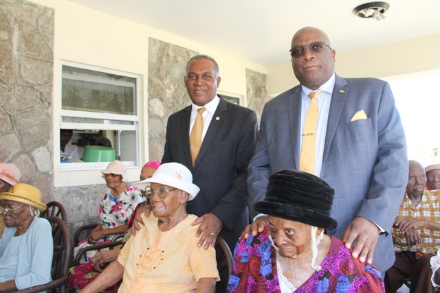 (l-r) Premier of Nevis Hon, Vance Amory and Prime Minister of St. Kitts and Nevis Hon. Dr. Timothy Harris with centenarians (seated l-r) Mrs. Rosetta “Rosie” Morton from Rawlins and Mrs. Artemisia “Etty” Jeffers from Hickmans and other residents at the Flamboyant Nursing Home in Nevis on January 19, 2017