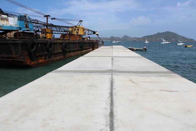 The new water taxi pier under construction at Oualie Bay on September 12, 2018, next to the barge being prepared for its departure from Nevis for its 10-hour journey to St. Marteen later in the day.
