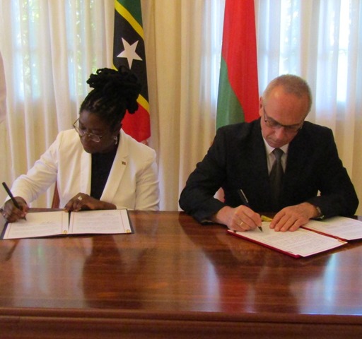 (L-r) Her Excellency Verna Mills, St. Kitts and Nevis Ambassador to Cuba and His Excellency Ambassador Aleksandr Aleksandrov sign visa waiver agreement in Cuba on October 19, 2018