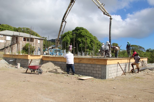 Workmen pouring the concrete for the flooring of the Gingerland Cultural Centre on Friday, February 01, 2019